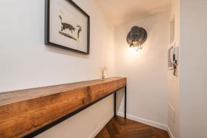 a hallway with a wooden counter on the wall at Cozy design apt in the heart of the city center in Cagliari