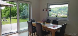 a dining room with a table and chairs and a large window at Villa FRIDA in Rogaška Slatina