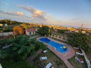 an overhead view of a pool with chairs and a house at Бирюза in Karolino-Buhaz