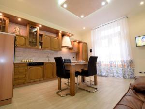 a kitchen with a wooden table and black chairs at Incanto d'Etna in Giarre