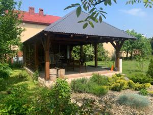 a pavilion with a table in a garden at Apartament z ogrodem Harcerska 4 in Zamość