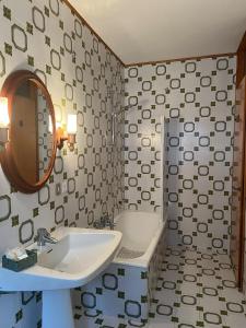 a bathroom with a sink and a mirror at Belvedere da Cesarina in Tarvisio +13 photos