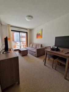 a living room with a couch and a table at Home sweet Valberg in Péone