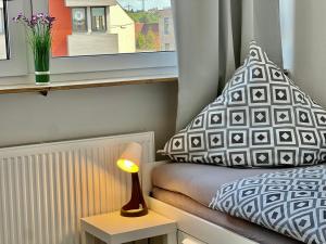 a small bedroom with a bed and a window at Nujen- Hotel und Apartment Stuttgart Zuffenhausen in Stuttgart