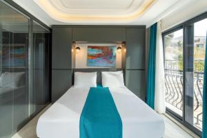 A bed or beds in a room at Gümüş Yazar Hotel