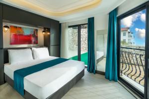 A bed or beds in a room at Gümüş Yazar Hotel