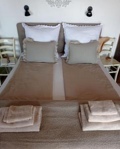 a bedroom with a bed with two pillows at Casa Delle Olive in Mošćenička Draga