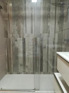 a shower with a glass door in a bathroom at Mi playa in Puerto de Sagunto