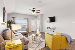 a living room with a couch and a yellow chair at Spacious 3/2 Kalahari Waterpark in Round Rock