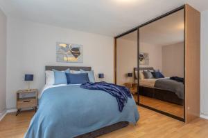 a bedroom with a bed and a large mirror at Templepatrick family home beside the Rabbit hotel in Templepatrick