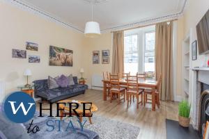 a living room with a couch and a dining room at Beautiful 2Bed Ground-F Pitt St. Apartment in Edinburgh