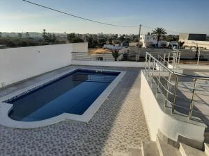 a swimming pool on the roof of a house at Villa de charme in Mezraya