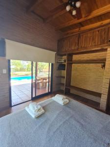 a bedroom with a bed with two towels on it at Cabaña Flor de Lis in San Javier +14 photos