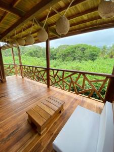 a porch with a bench on a wooden deck at Yaku Hostel in Playa Mendiguaca