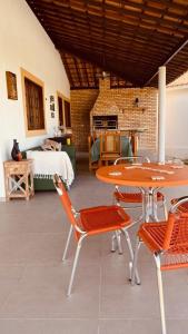a room with a table and chairs and a bedroom at Casa com piscina aquecida, privativa,diarista, em condomínio, Bonito-Pe in Bonito