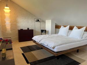 a bedroom with a large bed with white pillows at Altstadthaus - neu renoviert, barrierefrei in Murten