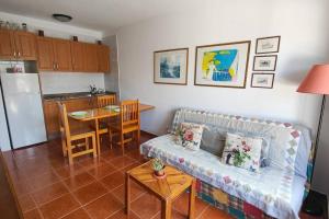 a living room with a couch and a kitchen at Sweet Flat with private patio Dunasol in Corralejo
