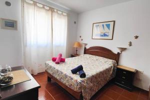 a bedroom with a bed with two objects on it at Sweet Flat with private patio Dunasol in Corralejo