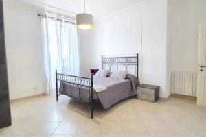 a bedroom with a bed in a white room at La Torretta Nettuno in Nettuno