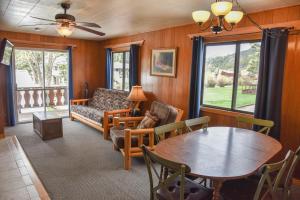 a living room with a table and a couch at Alpine Lodge Red River in Red River