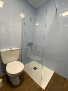 a bathroom with a toilet and a glass shower at Siestamar in Cala en Porter +6 photos