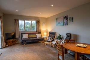 a living room with a couch and a table at Beachside Apartment in Hokitika