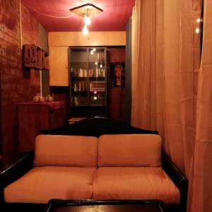 a couch sitting in a room with a bar at La Cueva in Imola
