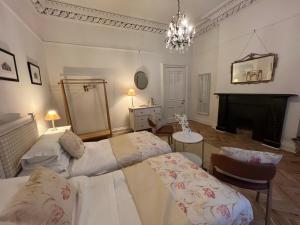 a living room with two beds and a fireplace at WM Garden Cottage in Edinburgh