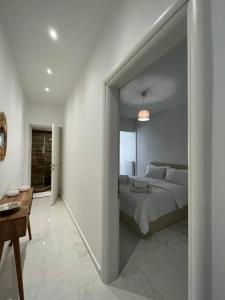 a bedroom with a bed and a room with a table at House in Diavata, Thessaloniki, Greece in Thessaloniki