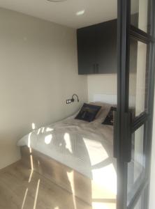 a bedroom with a bed with white sheets on it at Apartament HARMATA Jagiellońska 42 new 2023 in Warsaw