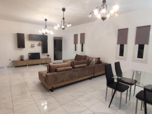 a large living room with a couch and a table at Mia casa in Naousa