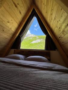 a bedroom with a window in a roof at Natures Escape Kozarica in Šavnik