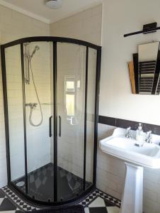 a bathroom with a shower and a sink at Pipers Hill in Sidmouth
