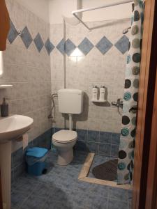 a bathroom with a toilet and a sink at Mata's House in Skiathos