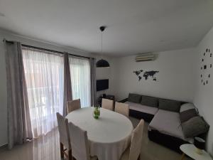 a living room with a table and a couch at Apartman Zrno in Vodice