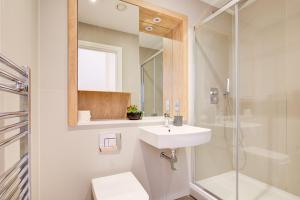 a bathroom with a sink and a shower and a toilet at The Landmark, Lutons best location in Luton