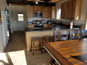 a kitchen with a wooden counter top and a wooden table at Sandcreek Cottage / Fabulous Views on Five Acres in Torrey