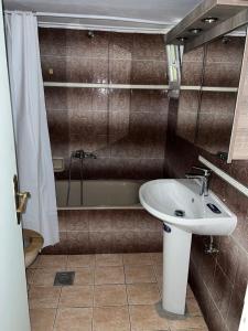 a bathroom with a sink and a bath tub at VALANTIS APARTMENT in Kavála +29 photos