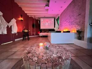 a large room with a table and a projection screen at Suite romance - Jacuzzi in Moret-sur-Loing