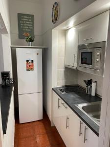 a small kitchen with a refrigerator and a sink at Apartamento Playa Chica Tenerife in San Andrés
