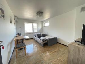 a living room with a couch and a table at Marble Apartament in Zamość