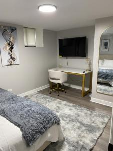 um quarto com uma cama, uma secretária e uma televisão em Modern 3 Bedroom Close to Downtown Chicago em Chicago