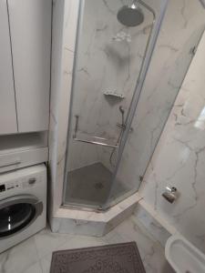 a shower with a glass door in a bathroom at Квартира ЖК Милениум парк in Promyshlennyy