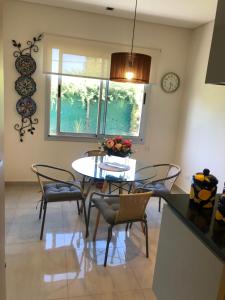 a dining room with a table and chairs and a clock at MENDOZA - CHACRAS DE CORIA - Bodegas, Viñedos, Valles in Mendoza
