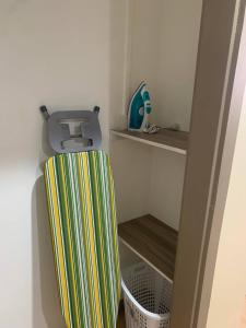 a corner of a room with a shelf and a container at Samoa Business Apartments in Apia