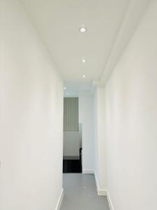 an empty hallway with white walls and ceilings at Canopy Aldgate in London