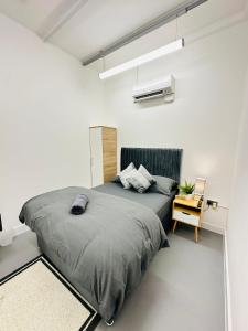 a bedroom with a large bed and a chair at Canopy Aldgate in London