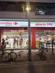 a bike parked in front of a store at night at Precioso estudio con dos ambientes in Madrid