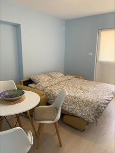 Schlafzimmer mit einem Bett, einem Tisch und Stühlen in der Unterkunft Popi in Budva