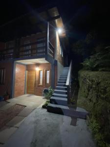 a house with stairs leading up to a building at night at Casa Canela in Canela